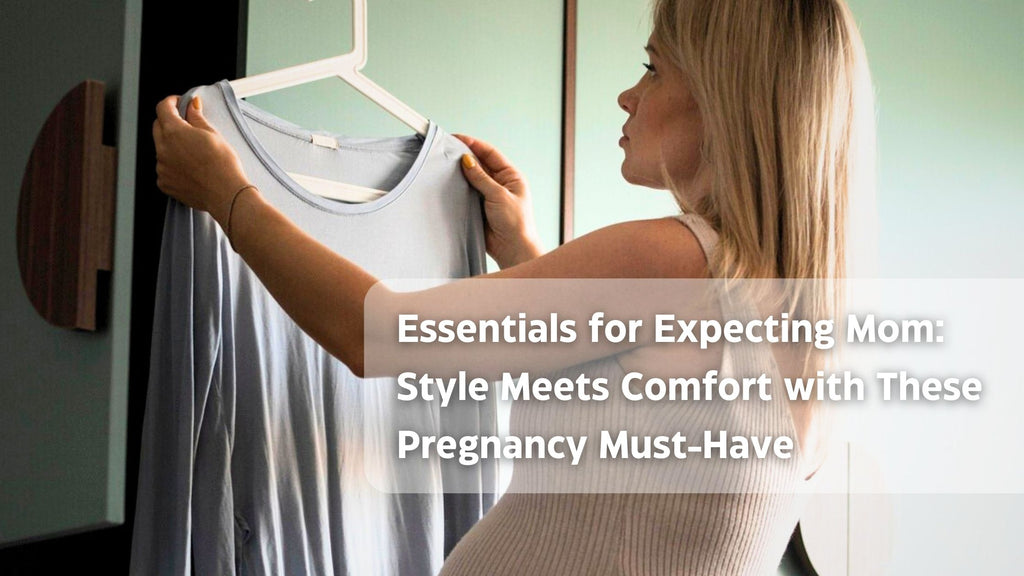 Woman examines gray tank top in maternity fashion article room with green wall